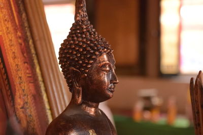 Close-up of buddha statue in temple