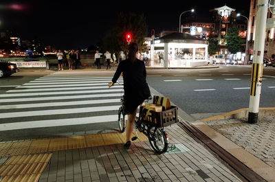 People walking on street at night