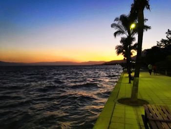 Scenic view of sea against clear sky during sunset