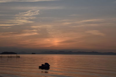 Scenic view of lake against sky during sunset