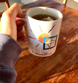 Midsection of person holding coffee cup