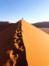 Scenic view of desert against clear sky