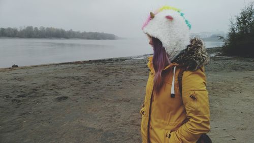 View of woman standing on lakeshore