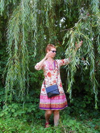 Woman standing against plants