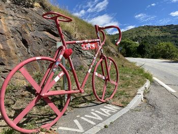Bicycle by road against sky
