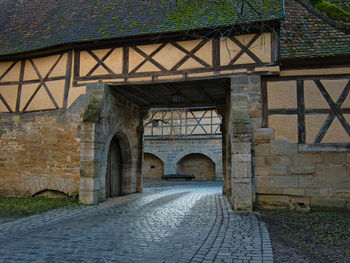 Arch bridge over street amidst buildings in city