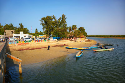 Boats in sea against clear sky