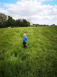 Rear view of boy on field