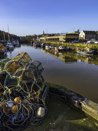 High angle view of harbor by river against sky