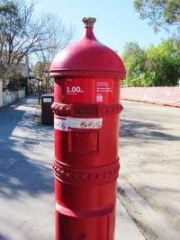 Red fire hydrant on footpath in city