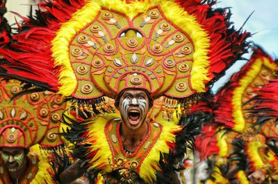 Portrait of young man in traditional clothing dancing on street