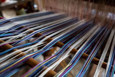 Close-up of thread in hand loom at factory