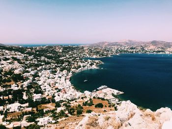 High angle view of townscape by sea against sky