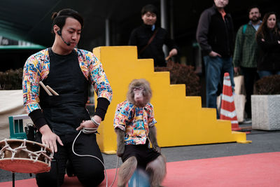 Man performing with monkey on street