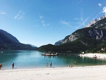 People on beach against sky