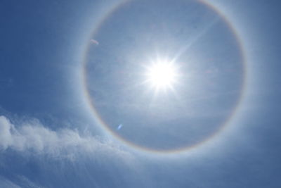 Low angle view of bright sun in sky