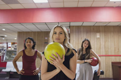 A young woman bowling.