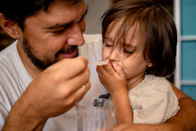 Side view of man drinking milk at home