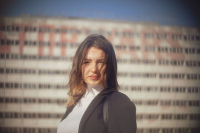 Portrait of beautiful young woman standing outdoors