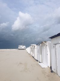 Lifeguard hut on beach against sky