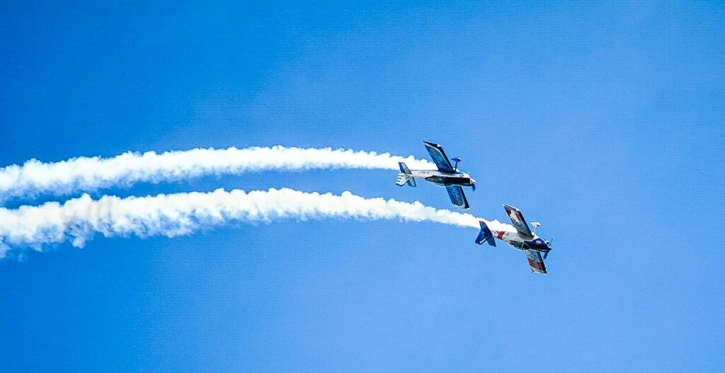 transportation, mode of transport, air vehicle, airplane, flying, mid-air, low angle view, travel, blue, on the move, clear sky, journey, copy space, helicopter, extreme sports, speed, motion, adventure, airshow