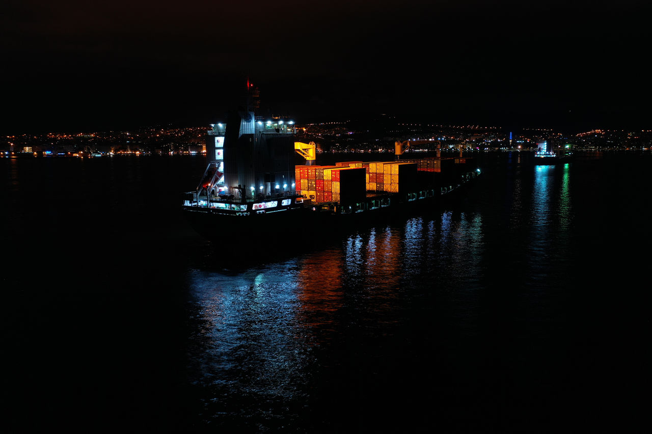 water, night, reflection, architecture, illuminated, darkness, built structure, building exterior, dusk, city, evening, transportation, nautical vessel, no people, light, travel destinations, ship, nature, building, sky, sea, mode of transportation, vehicle, waterfront, skyline, outdoors, travel, cityscape, copy space