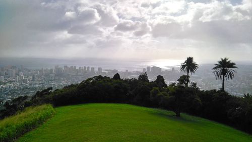 Scenic view of green landscape against sky