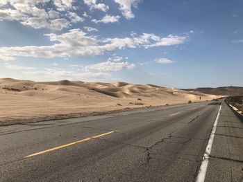 Road on desert against sky