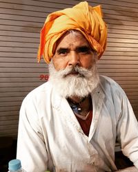 Portrait of bearded man wearing turban against shutter