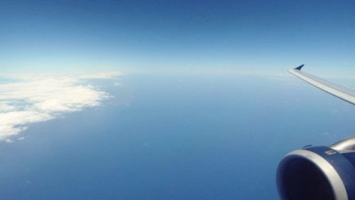 Cropped image of airplane flying over sea