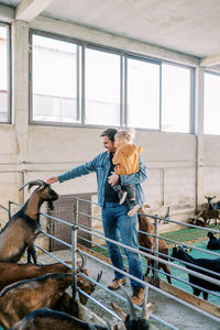 Side view of young man working at farm