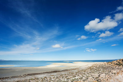 Scenic view of beach against blue sky