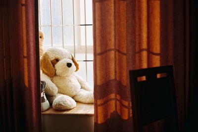 Close-up of stuffed toy on window sill