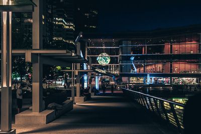 Man in illuminated city at night