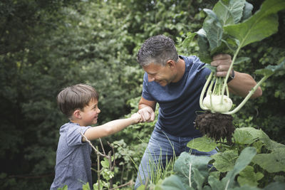 Father and son with plants