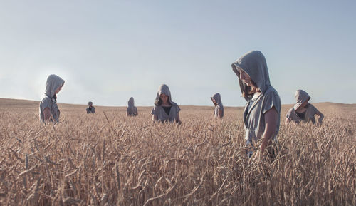 Multiple image of woman on field against clear sky