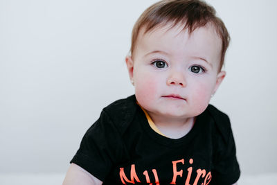 Portrait of cute boy against white background