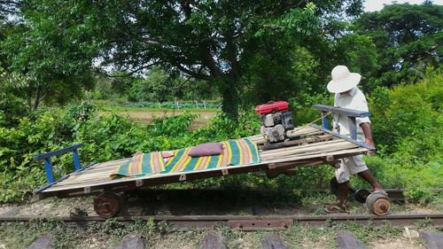 Man working on plants by railroad track