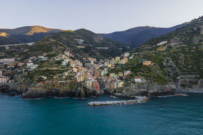 Scenic view of sea and mountains against sky