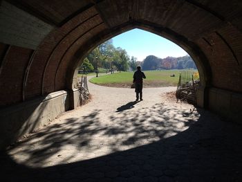 Silhouette of man in tunnel