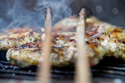 Close-up of pork cooking on barbecue grill