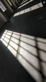 High angle view of sunlight falling on tiled floor in building