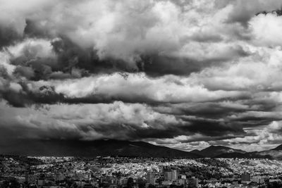 Cityscape against cloudy sky