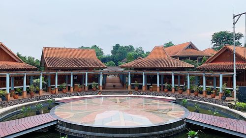 View of swimming pool by building against sky