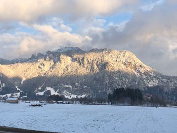 Scenic view of snow covered mountains against sky