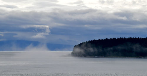 Dramatic clouds and fog on the ocean shore