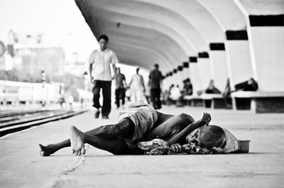 People lying on floor in city