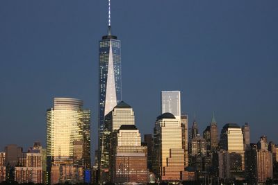 Low angle view of skyscrapers against blue sky