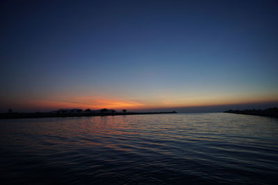 Scenic view of sea against orange sky