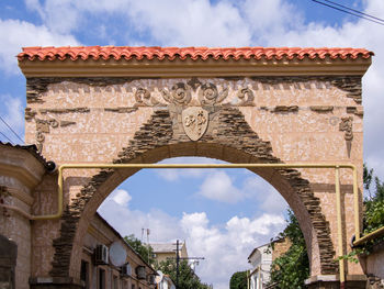 Low angle view of old building against cloudy sky